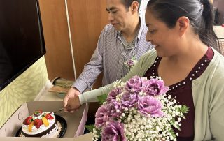 bride and groom cut their wedding cake in a hospital room at Highland Hospital