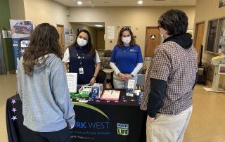 Donor West staff sharing information at tabling event at Highland Hospital.