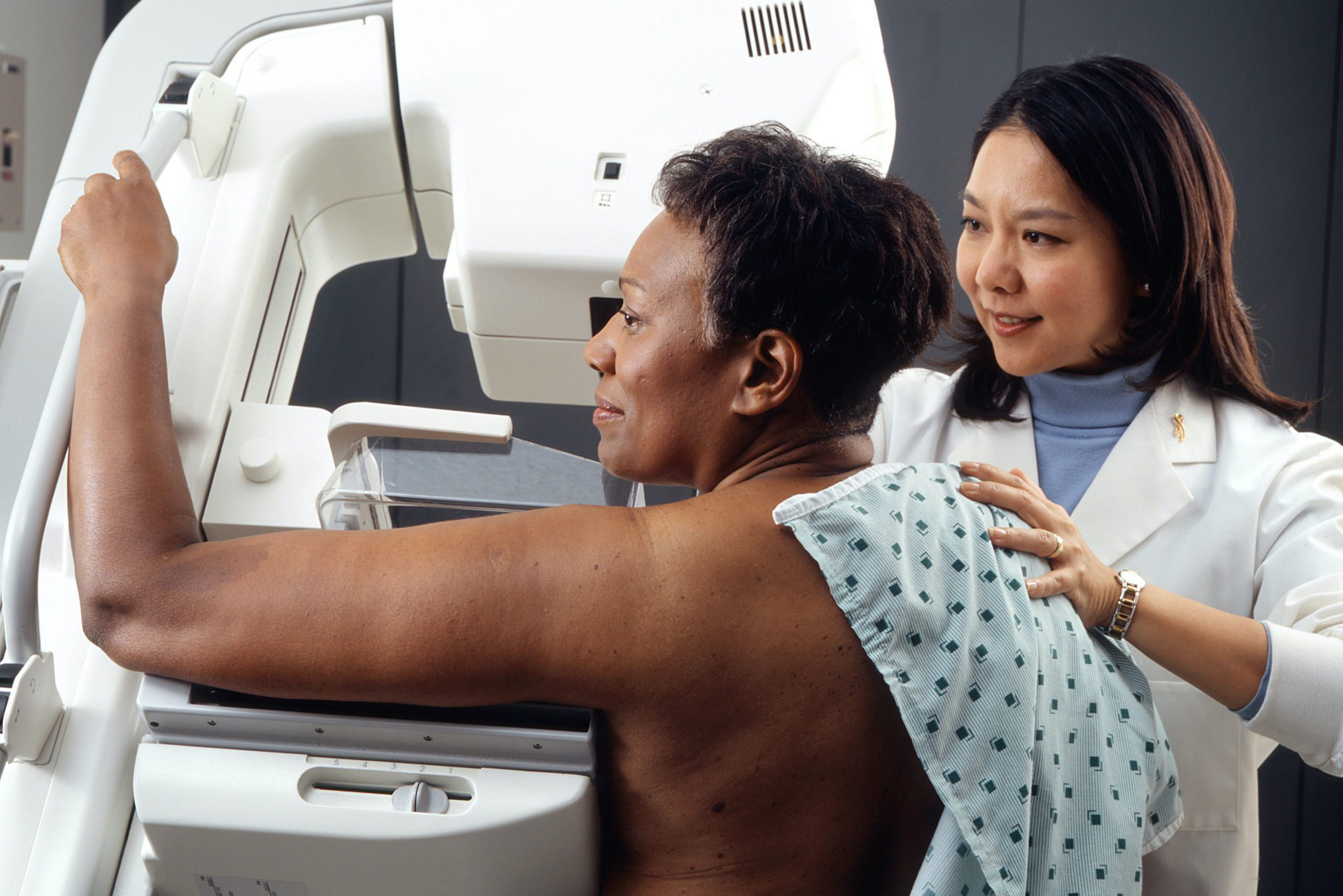 Woman getting breast cancer radiology screening.