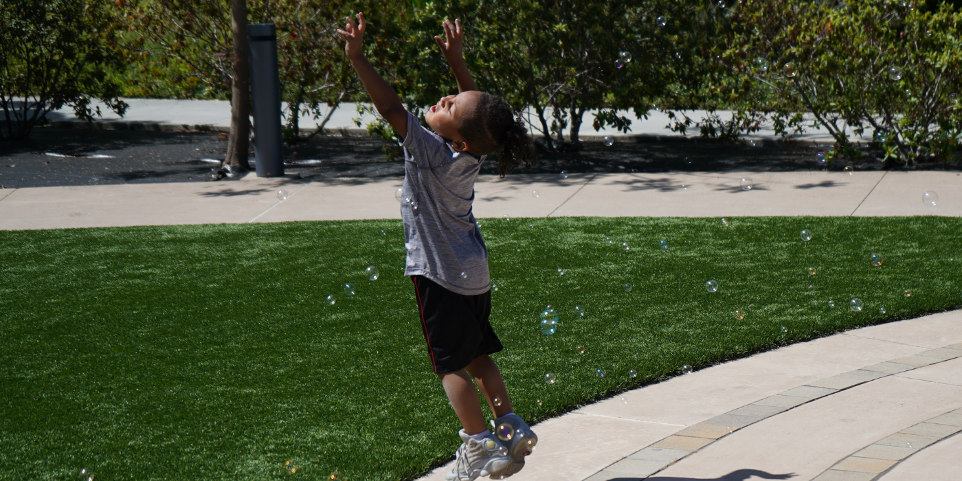 March-CEO-Banner3 Boy playing with bubbles